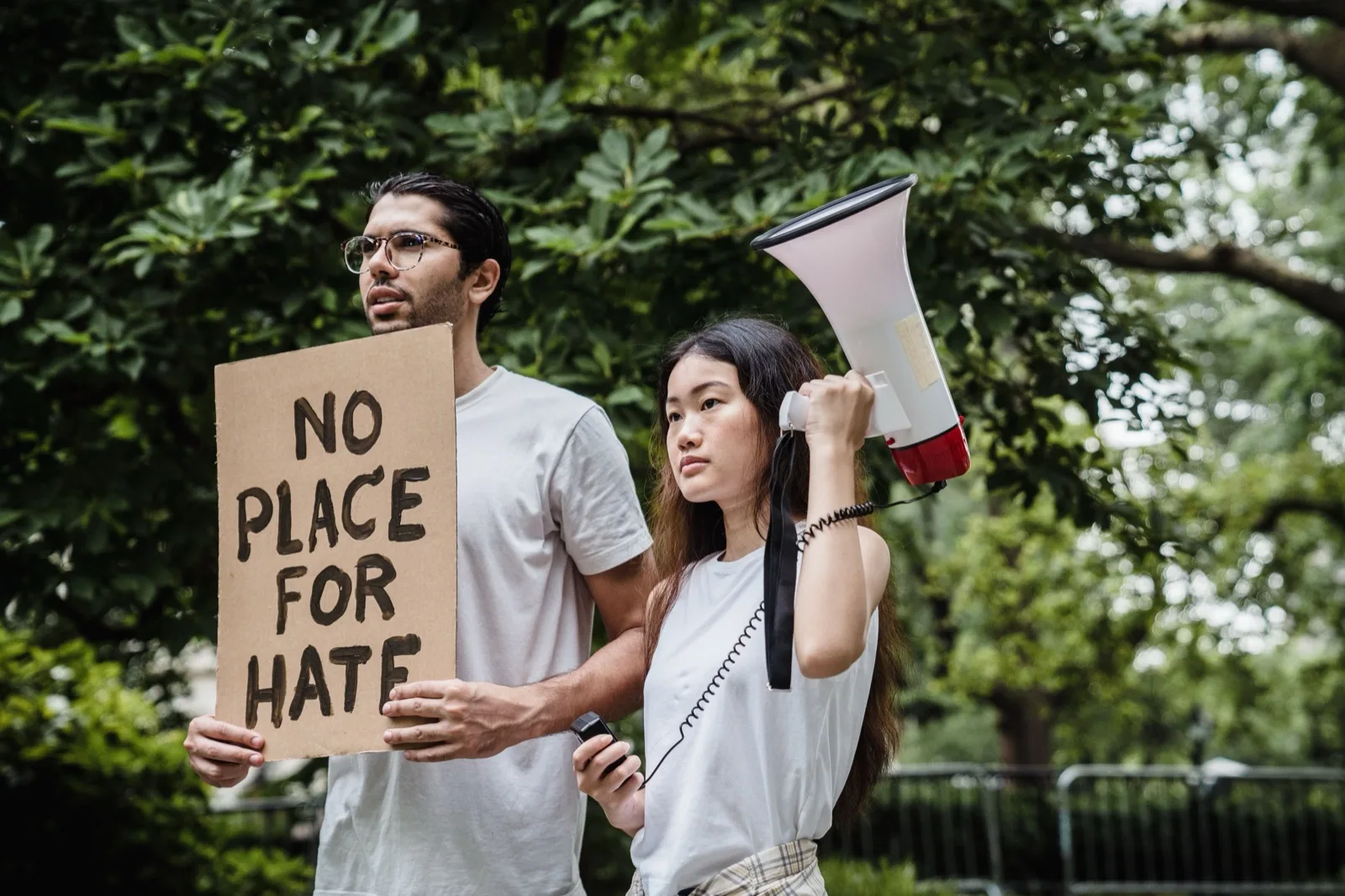 Two protesters holding a cardboard sign and a megaphone during a peaceful demonstration (photo: Pexels, https://www.pexels.com/photo/protesters-holding-cardboard-and-megaphone-8898655/)